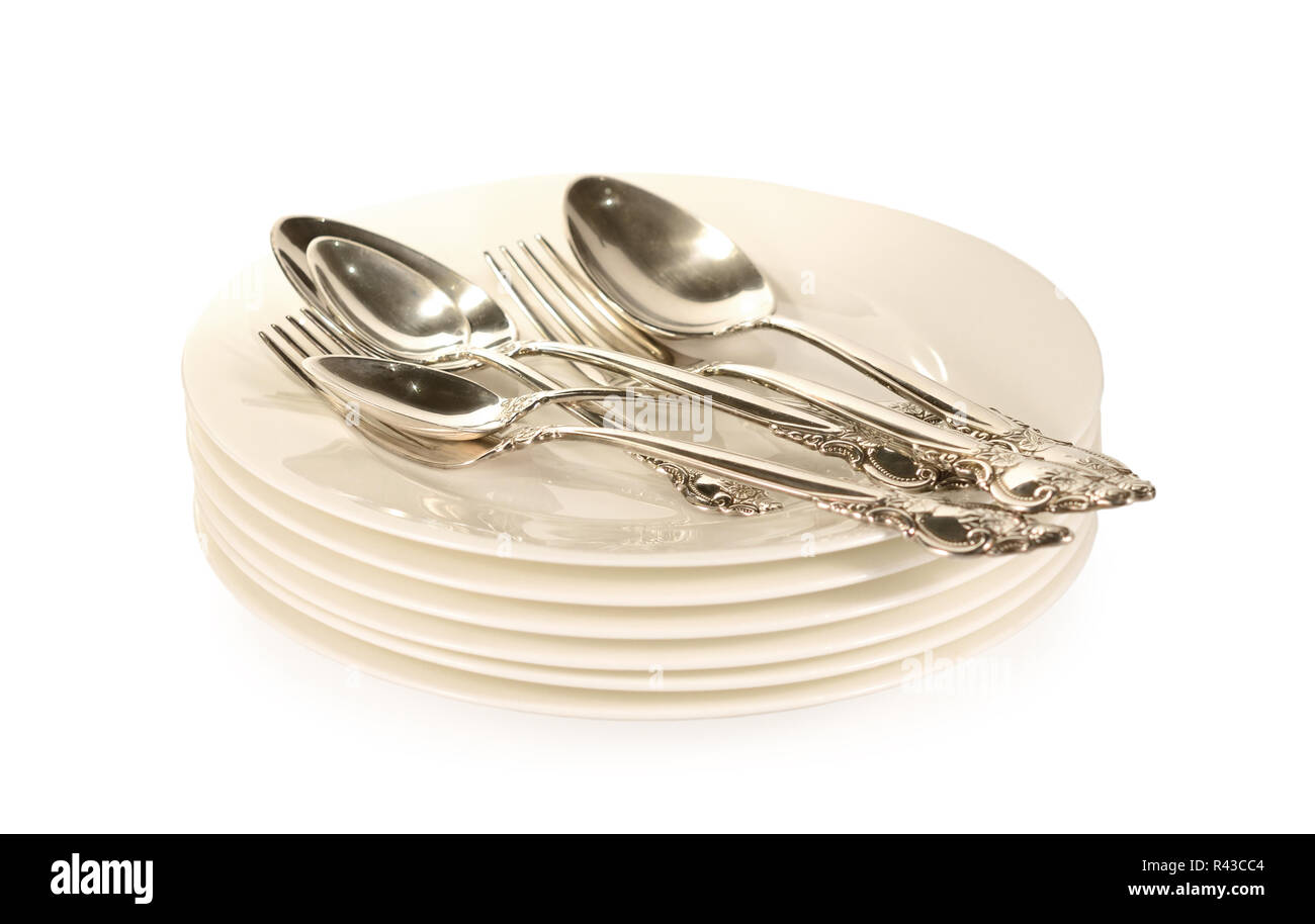 Silver spoons and forks on plates Stock Photo
