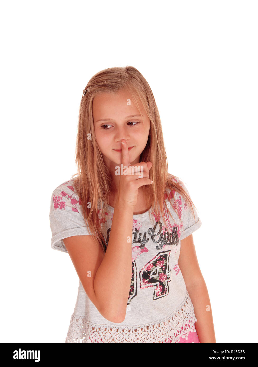 Young pretty girl with finger over mouth. Stock Photo