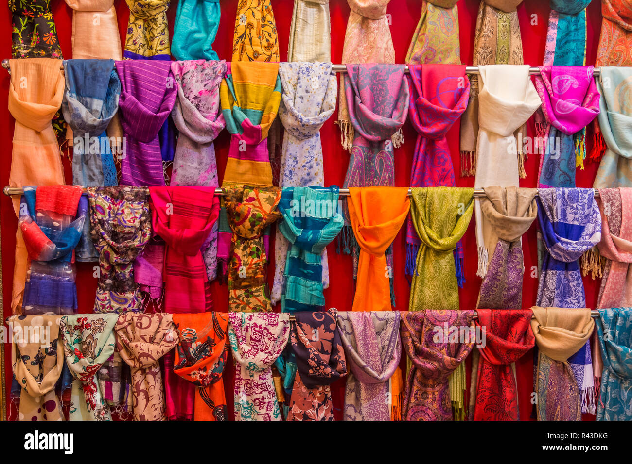 Colorful scarfs on display on racks in a bazaar. Stock Photo