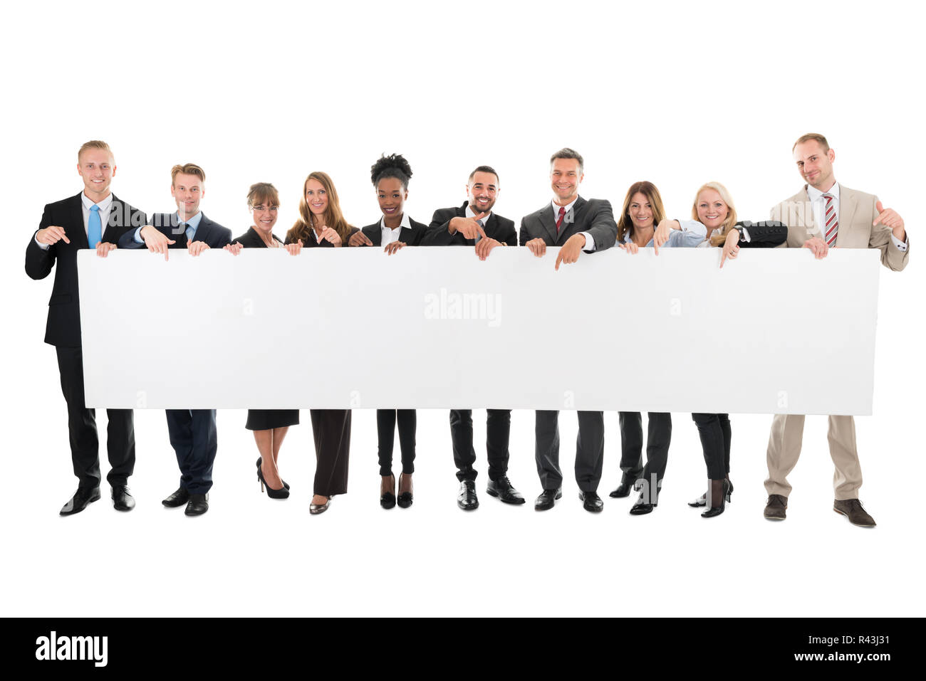 Happy Business Team Pointing At Blank Billboard Stock Photo