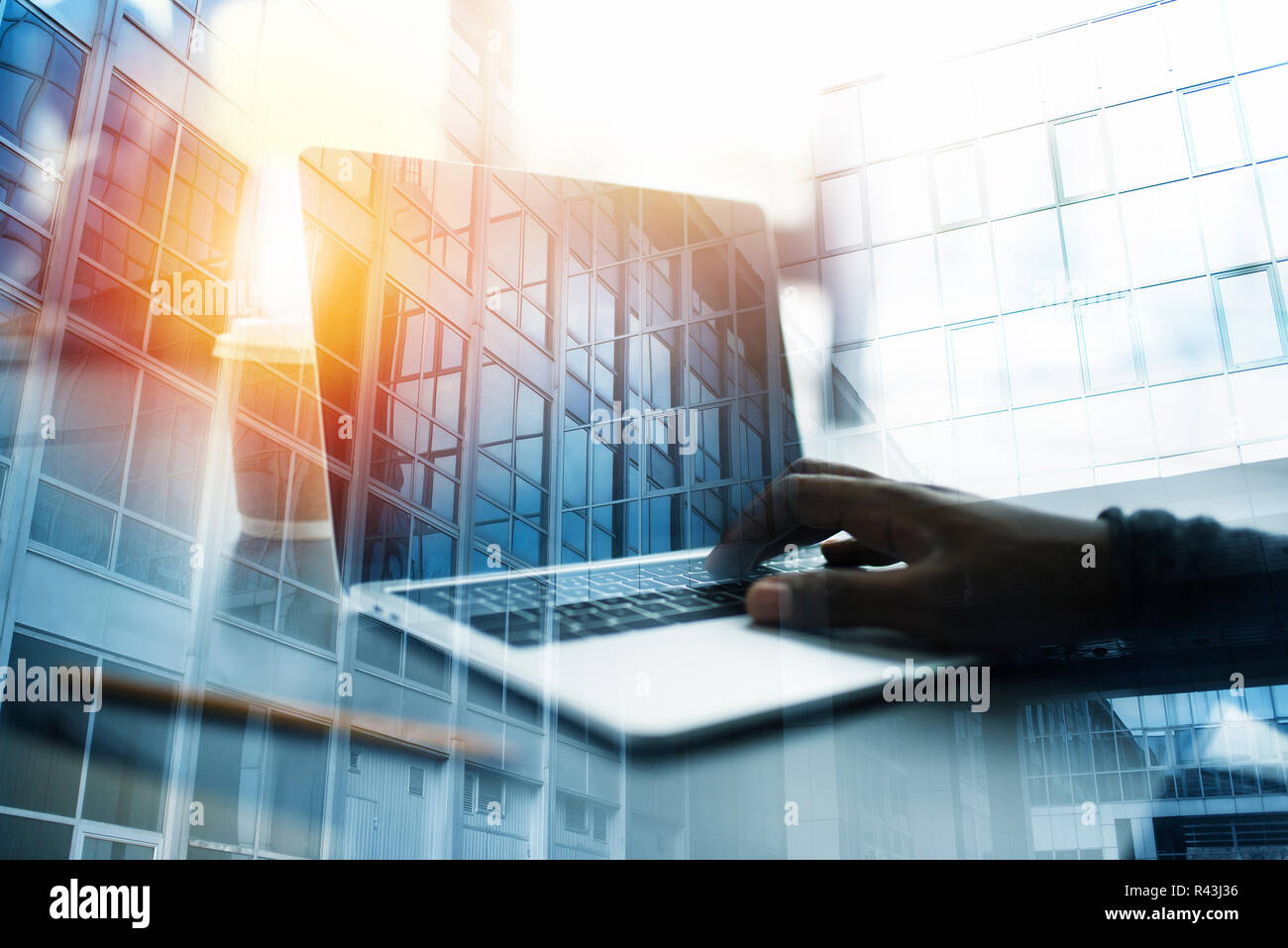 Businessman works in office with a laptop. Concept of internet sharing. double exposure Stock Photo