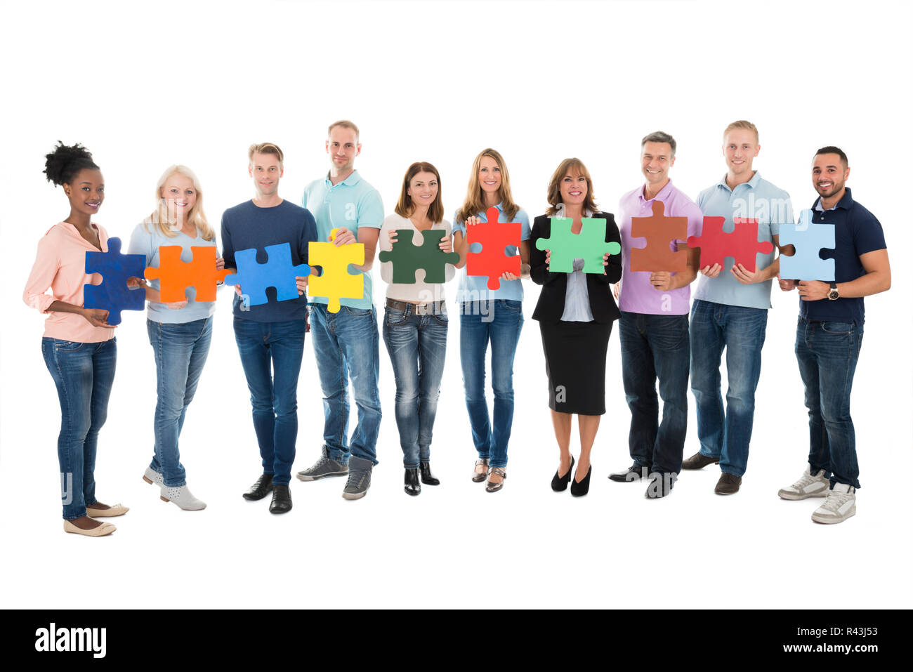 Creative Business People Holding Jigsaw Pieces Stock Photo