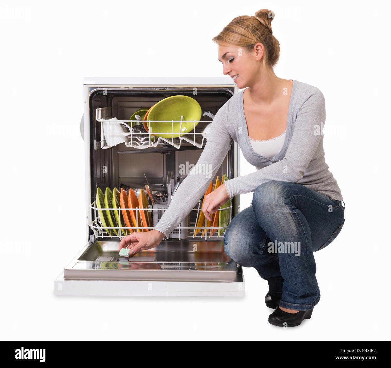 Young Woman Placing Soap In Dishwasher Stock Photo Alamy