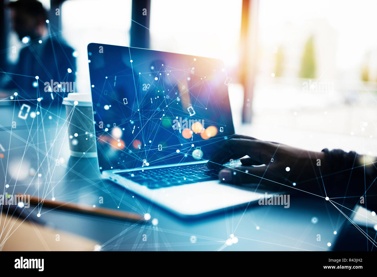 Businessman works in office with a laptop with internet effects. Concept of internet sharing and company startup Stock Photo