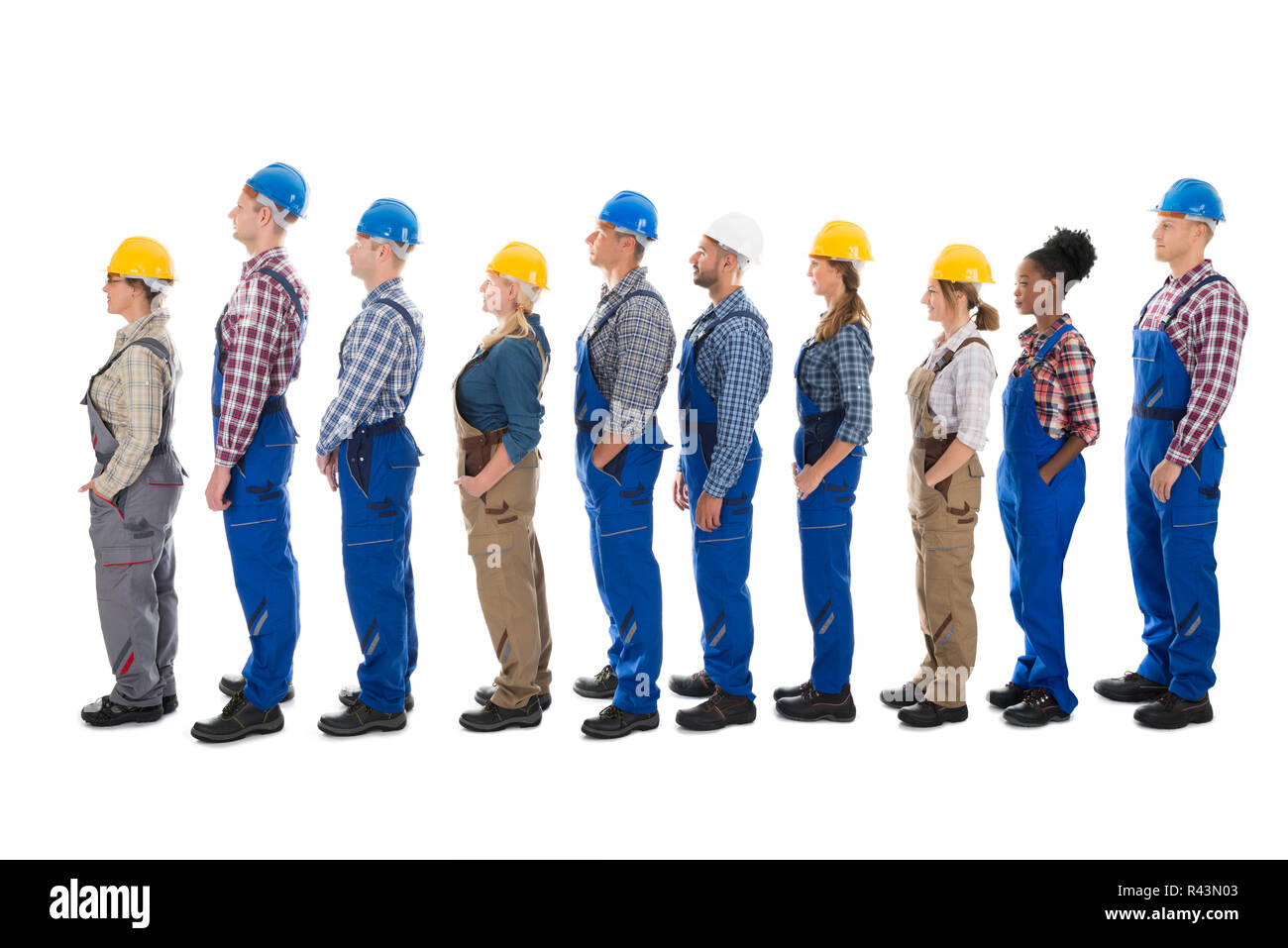 Side View Of Carpenters Standing In Line Stock Photo
