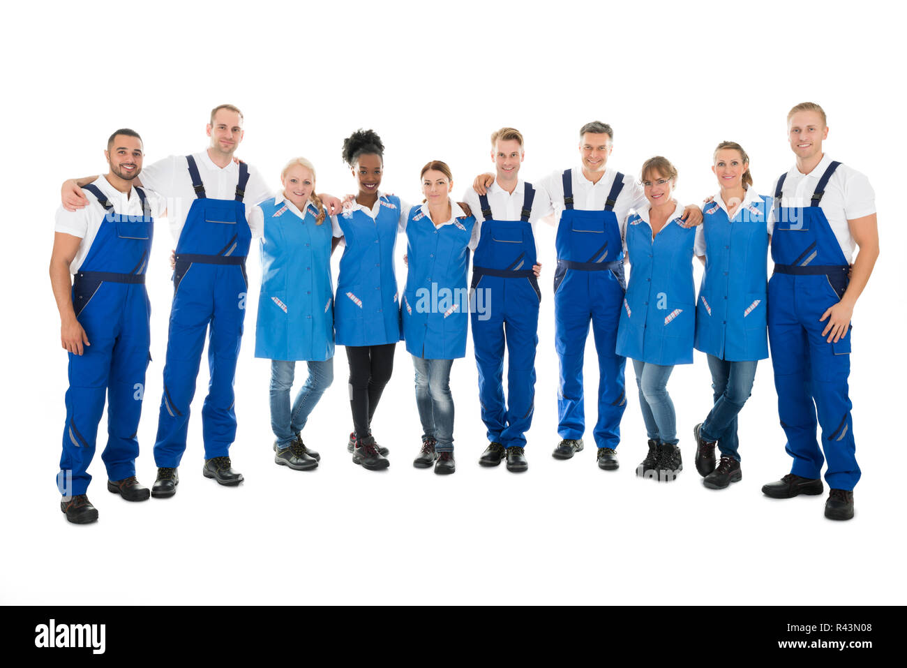 Confident Multiethnic Janitors Standing With Arms Around Stock Photo