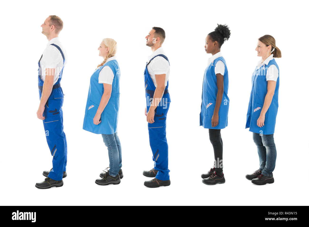 Side View Of Multiethnic Janitors Standing In Queue Stock Photo