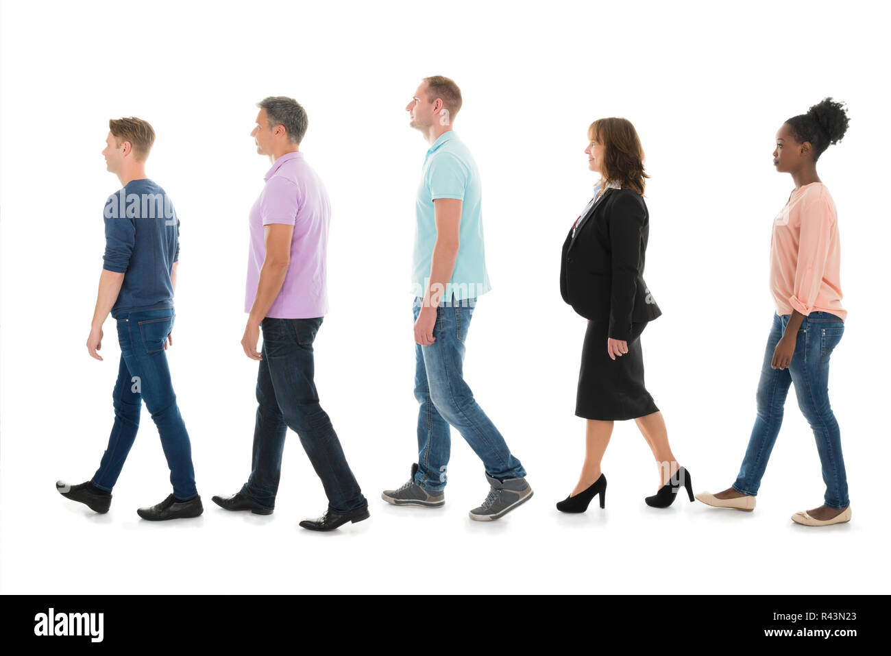 Creative Business People Walking With Manager In Row Stock Photo