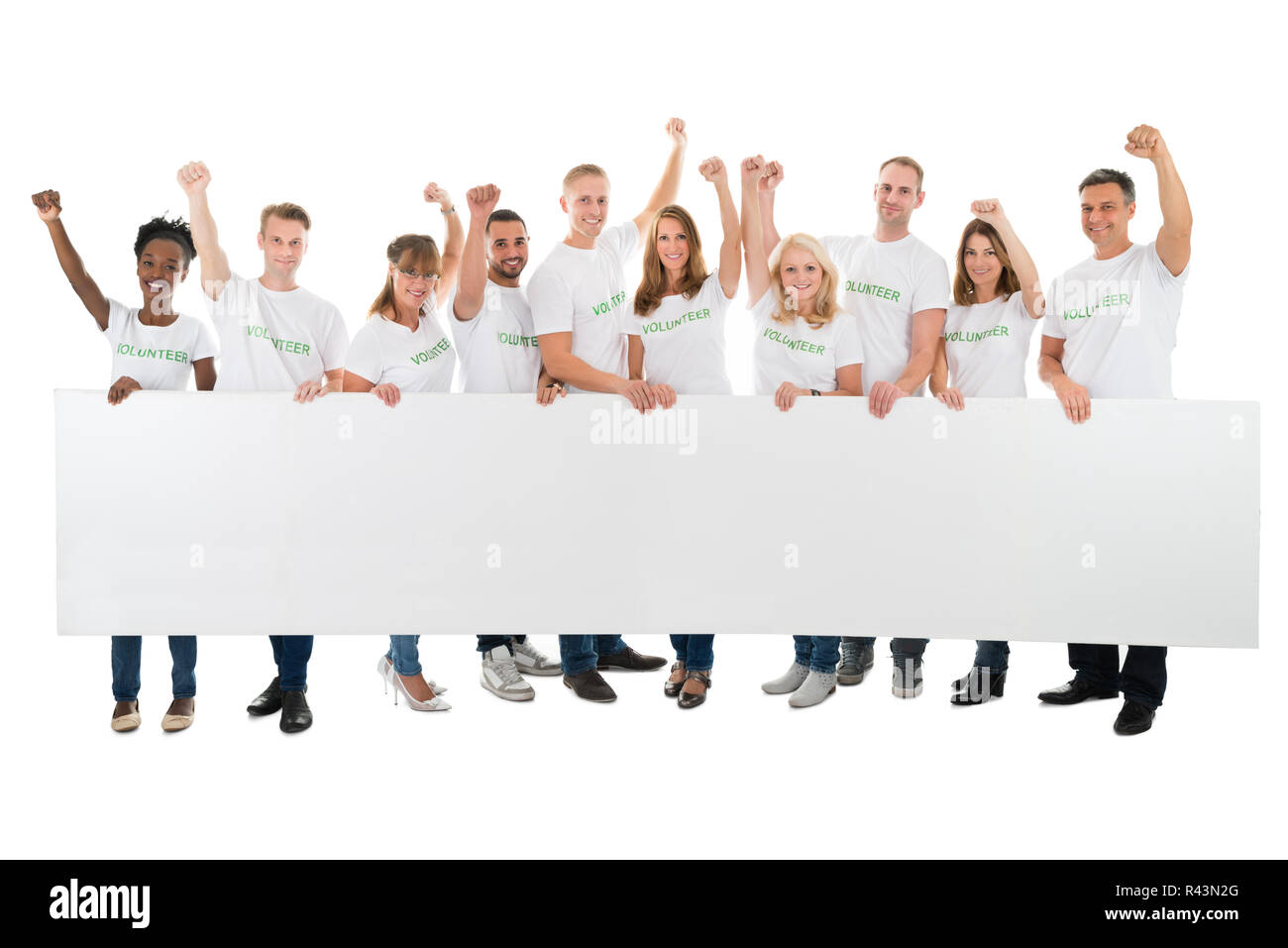 Confident Volunteers With Arms Raised Holding Blank Billboard Stock Photo