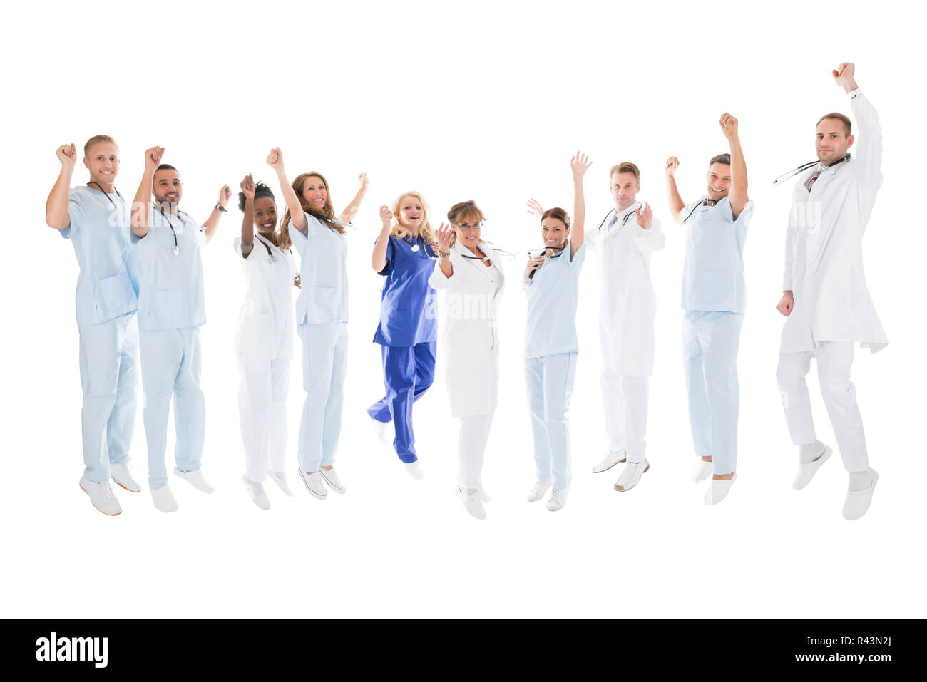 Multiethnic Medical Team Standing With Arms Raised Stock Photo