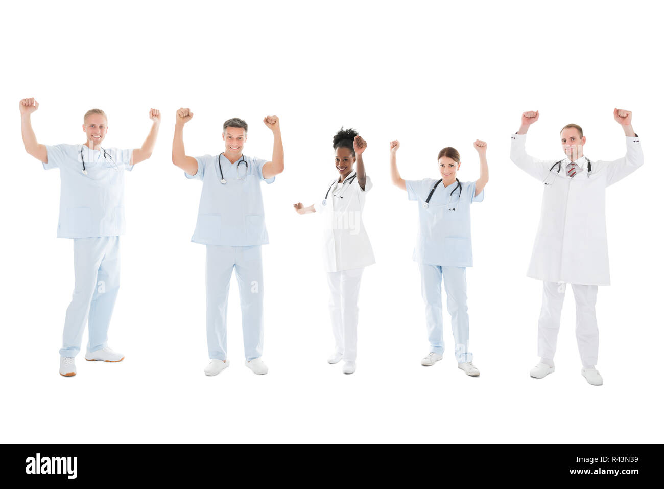 Multiethnic Medical Team Standing With Arms Raised Stock Photo