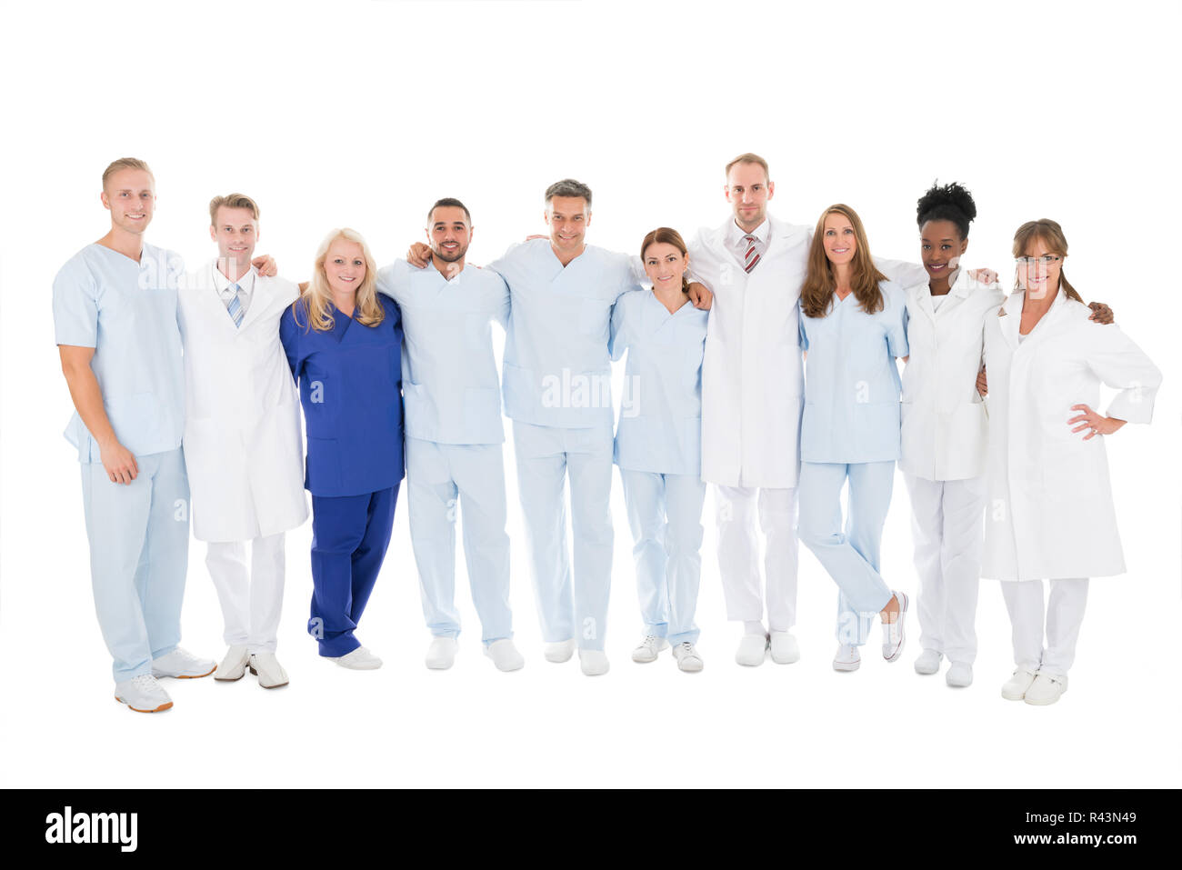 Confident Medical Team Standing With Arms Around Stock Photo