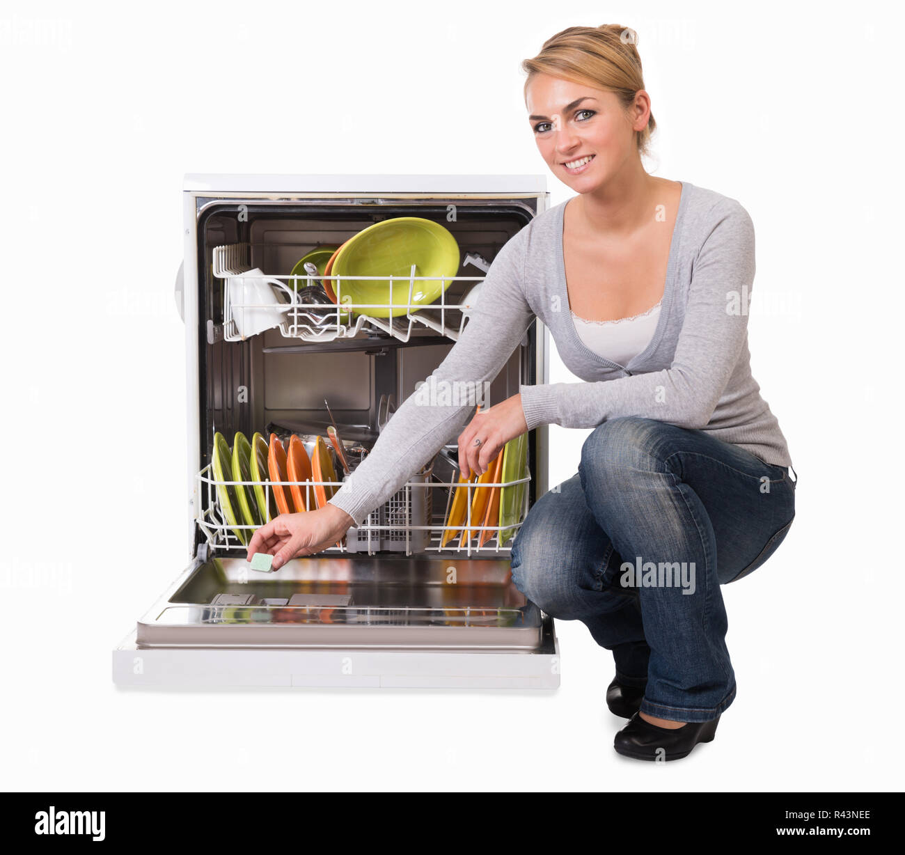 Young Woman Placing Soap In Dishwasher Stock Photo Alamy