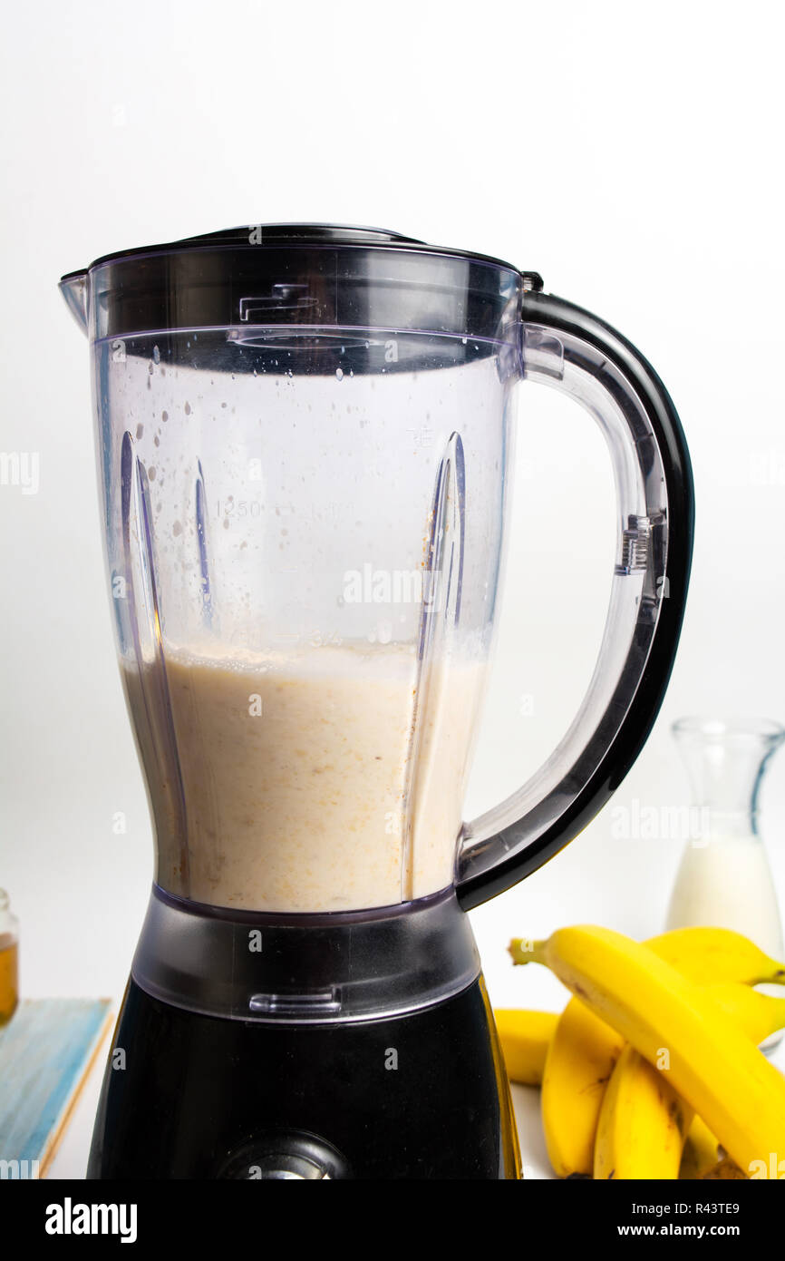 Banana healthy smoothie making in a blender Stock Photo Alamy