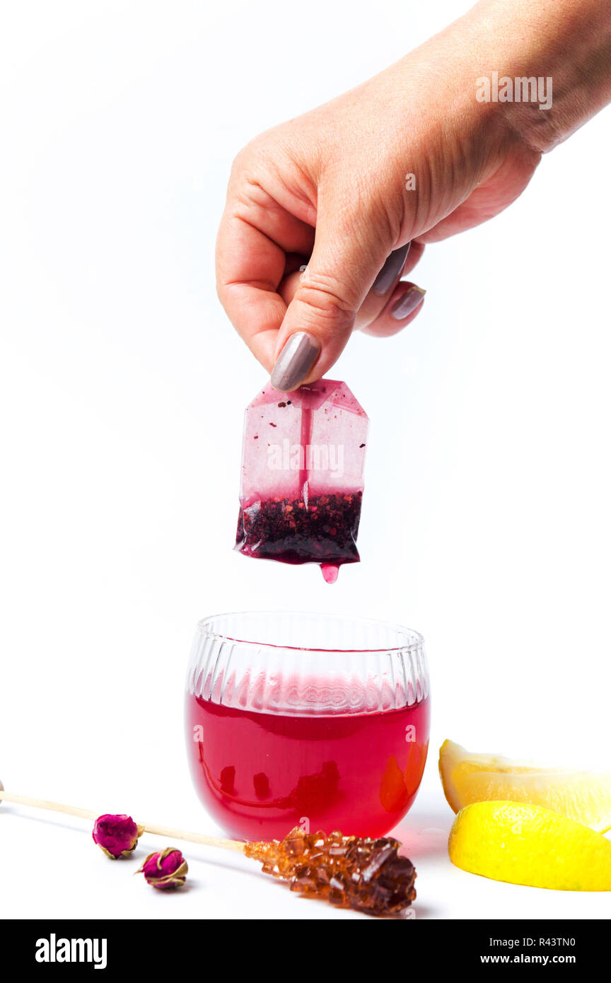 Hand taking out tea bag out of the glass isolated Stock Photo Alamy
