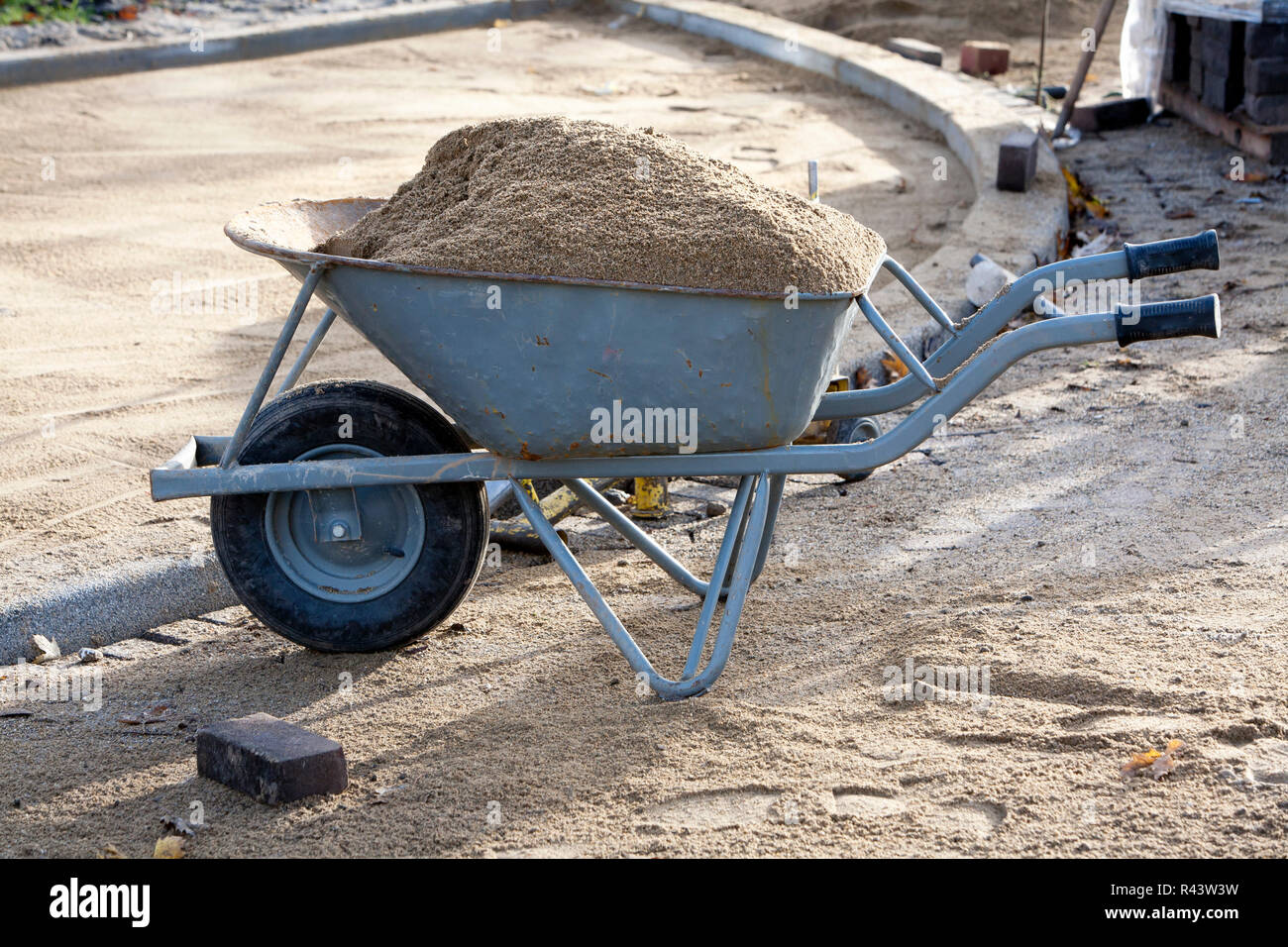 Wheelbarrow loaded with sand Stock Photo Alamy