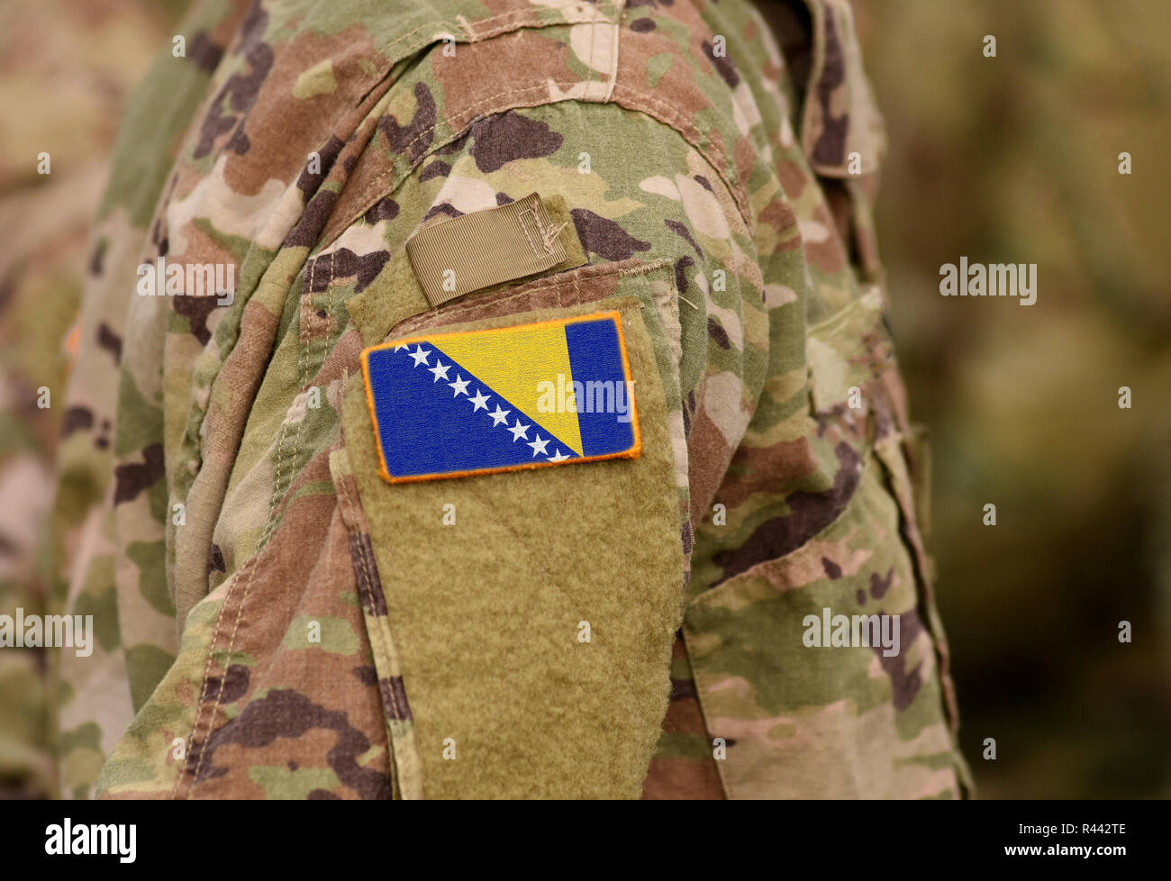 Bosnia and Herzegovina flag on soldiers arm (collage). Stock Photo