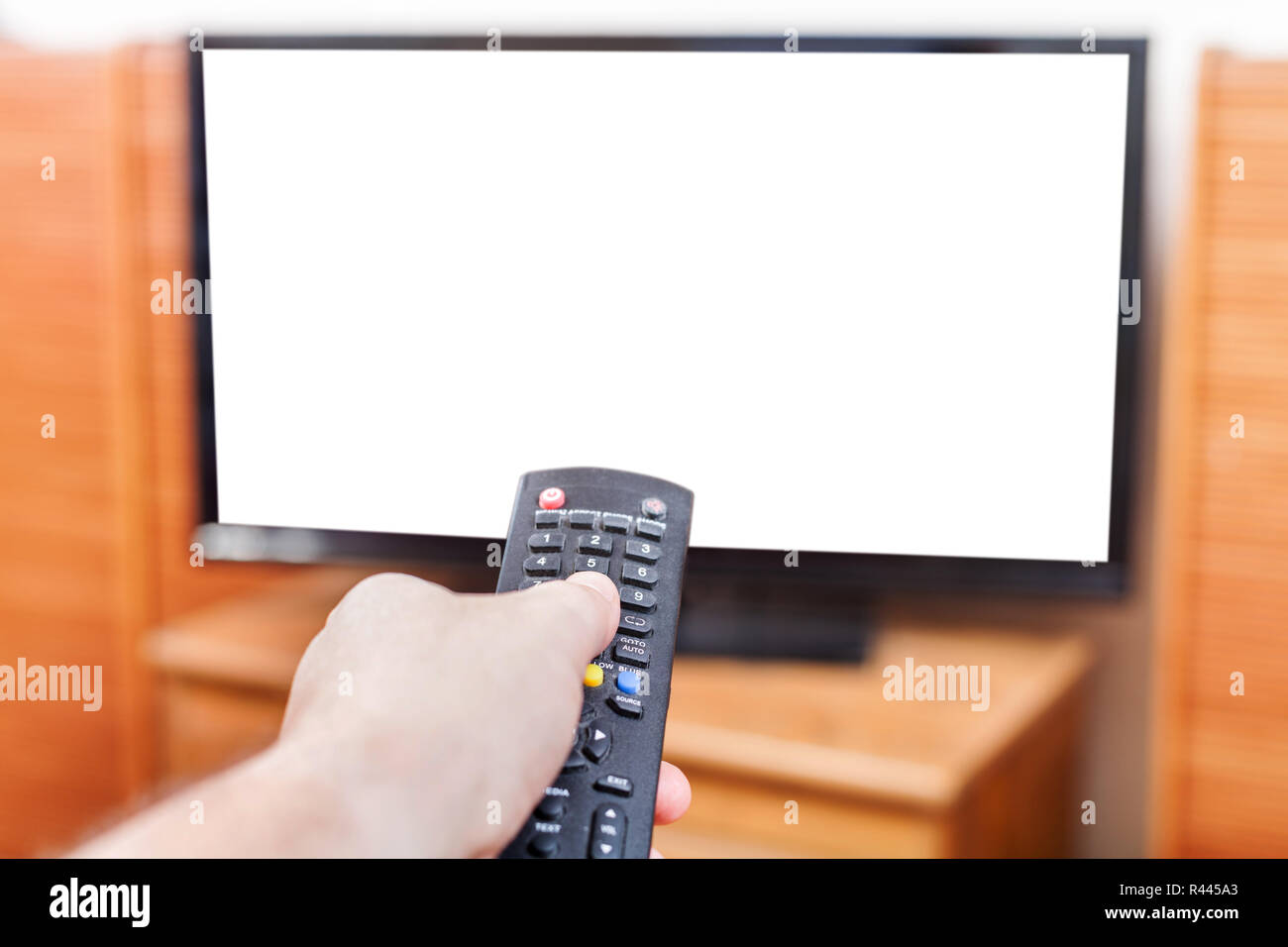 Hand switches TV channels with cut out screen Stock Photo Alamy