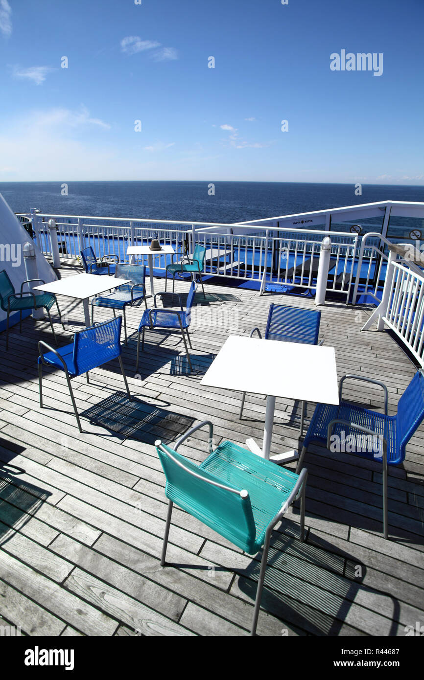 Chairs and tables on a ferry deck Stock Photo