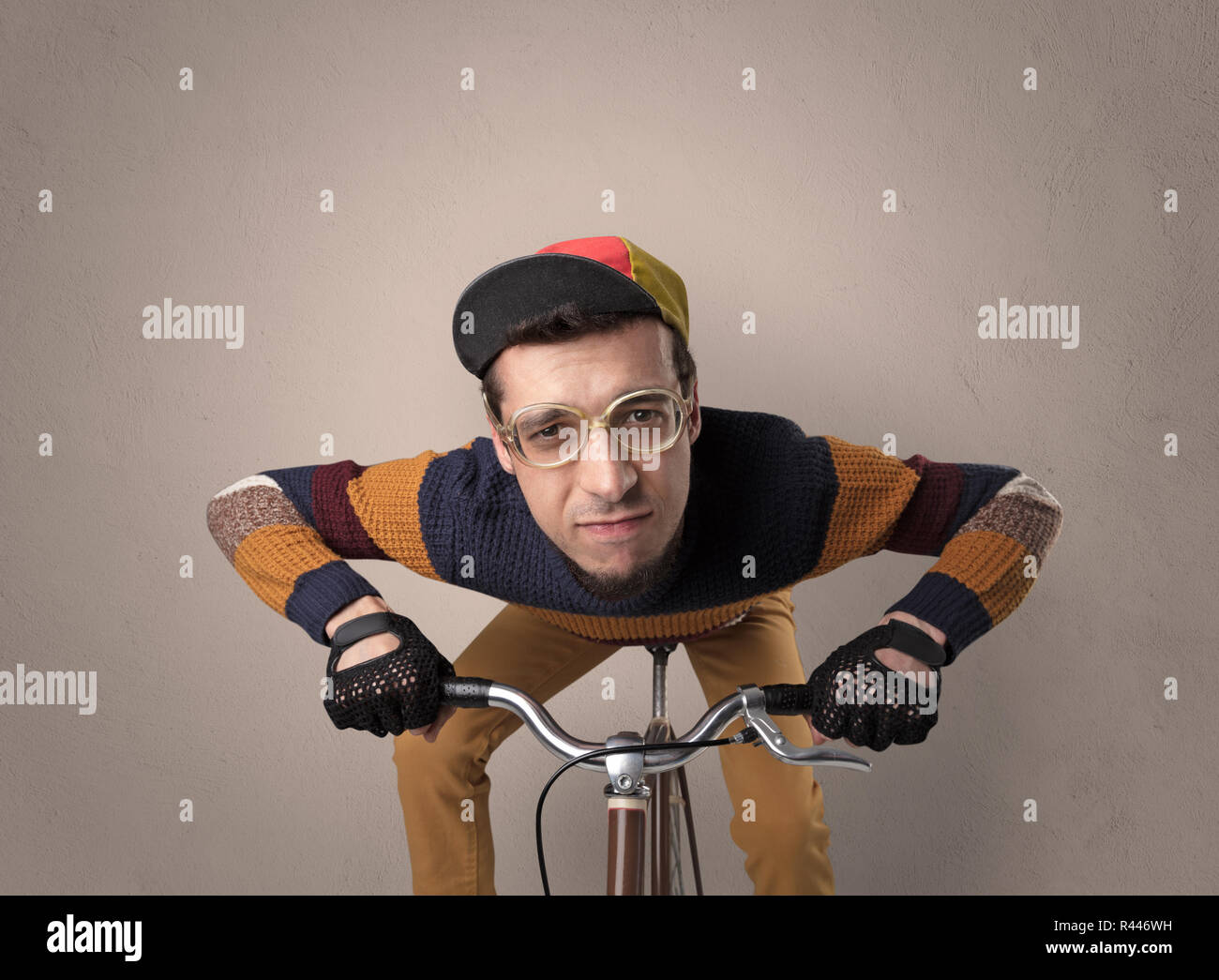 Nerd young foolish biker on a bike with oldschool outfit Stock Photo ...