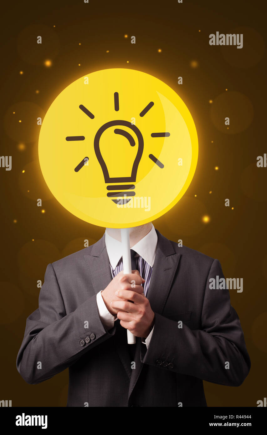 Smart businessman holding round sign with yellow lightbulb Stock Photo