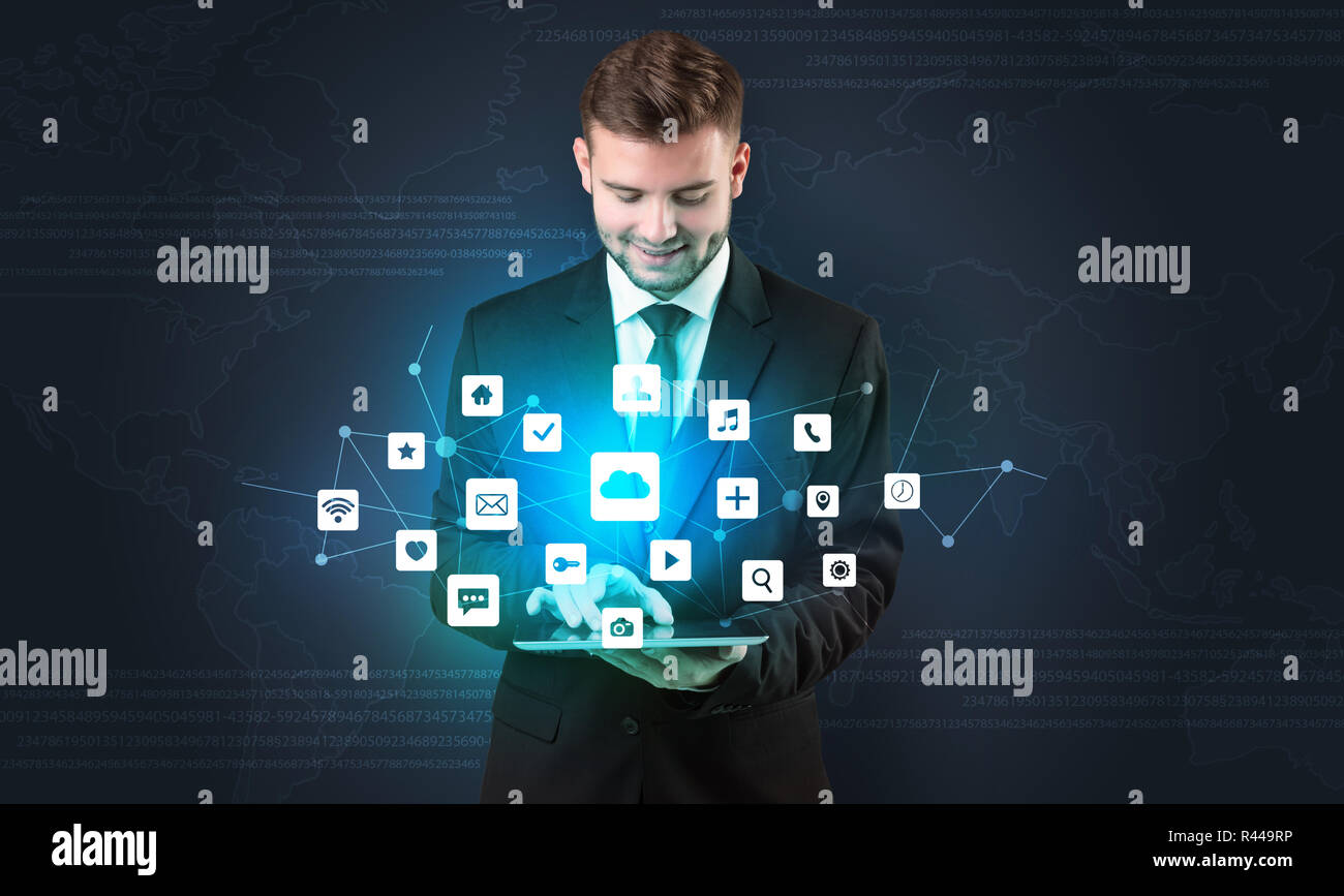 Handsome businessman in suit with tablet on his hand and application ...