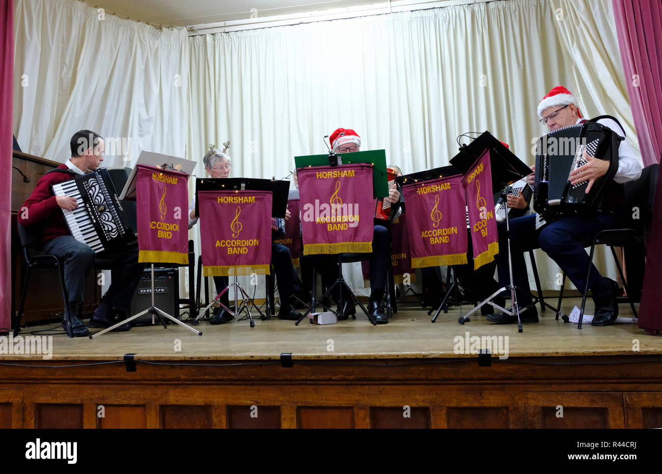 Horsham Accordion Band performing on stage in East Preston village as part of the village's Christmas celebrations. Stock Photo