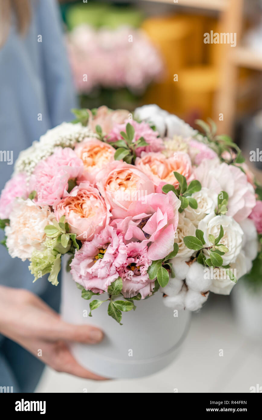 floral bunch in head box. European floral shop. Bouquet of beautiful Mixed flowers in woman hand. Excellent garden flowers in the arrangement , the work of a professional florist. Stock Photo