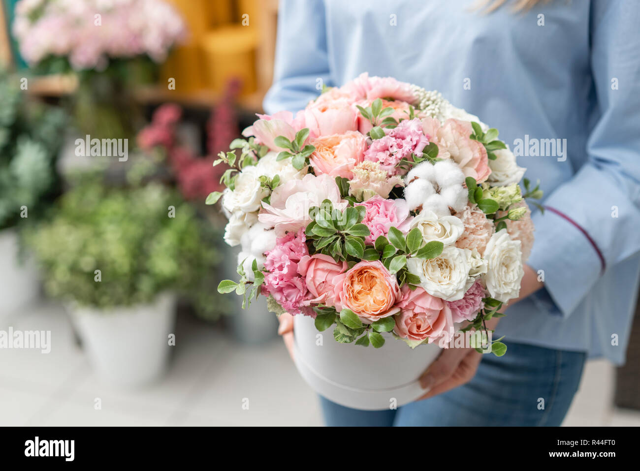floral bunch in head box. European floral shop. Bouquet of beautiful Mixed flowers in woman hand. Excellent garden flowers in the arrangement , the work of a professional florist. Stock Photo