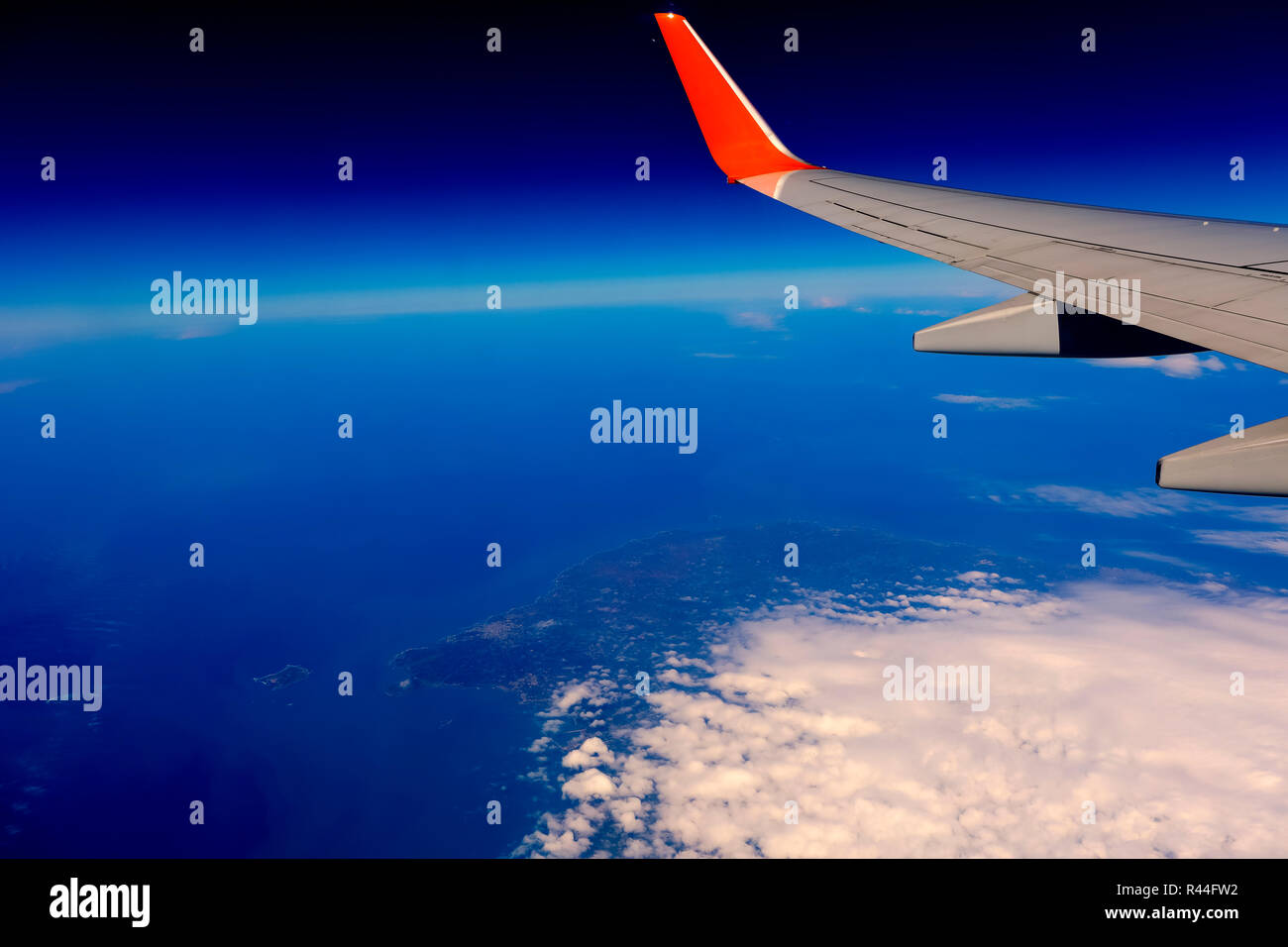 airplane wing over the blue cloud sky Stock Photo - Alamy