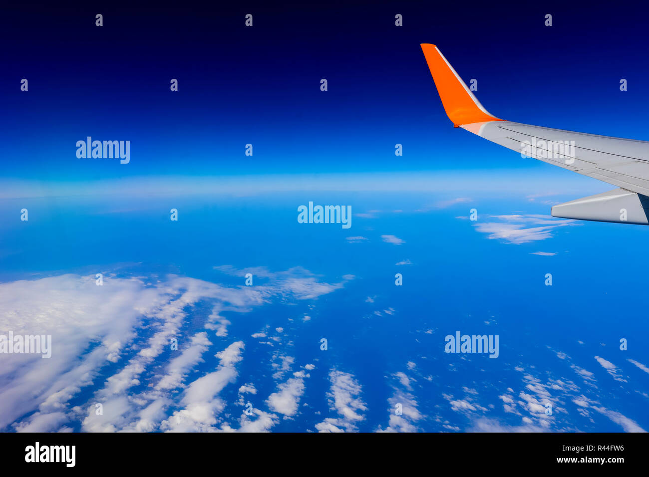 airplane wing over the blue cloud sky Stock Photo - Alamy