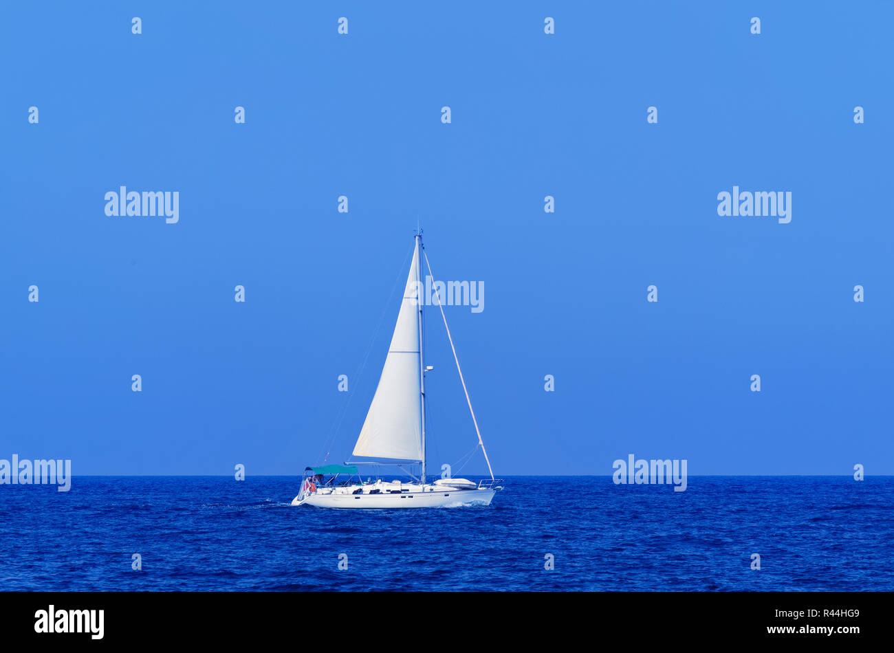 Single white yacht in open sea against clear blue sky. European island state of Malta Stock Photo