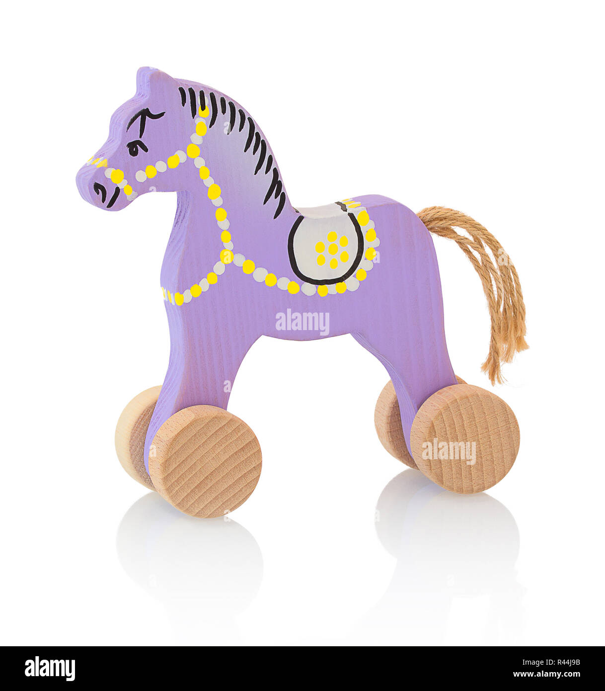 Children's small wheeled wooden horse isolated on the white background with shadow reflection. Small childish wooden pinky toy in the shape of horse o Stock Photo