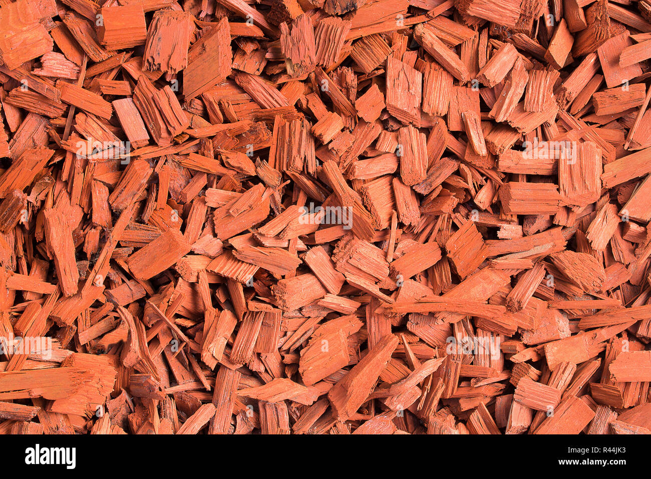 Red wood chips. Natural texture background of red wooden pieces of tree