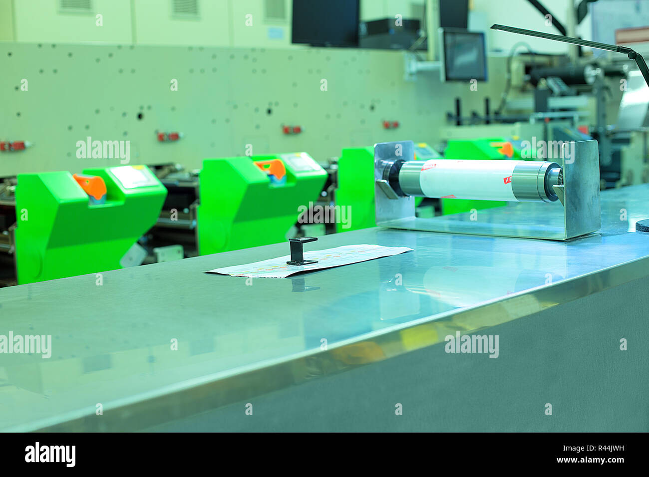 Picture of flexographic printing press in background, print sample