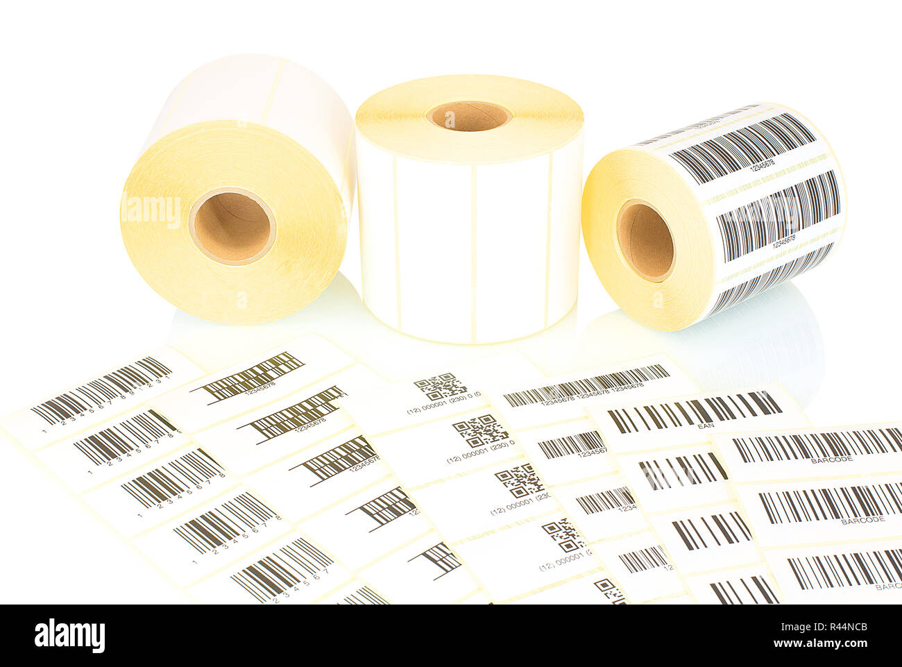 White label rolls and printed barcodes isolated on white background with shadow reflection. White reels of labels for printers. Labels for direct ther Stock Photo