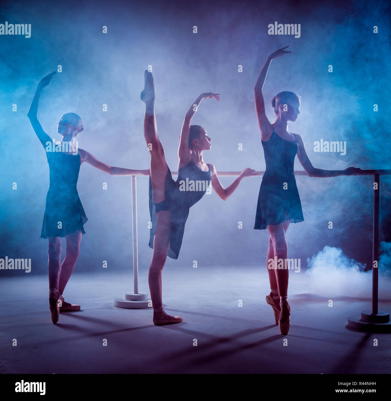 The young ballerinas stretching on the bar Stock Photo - Alamy