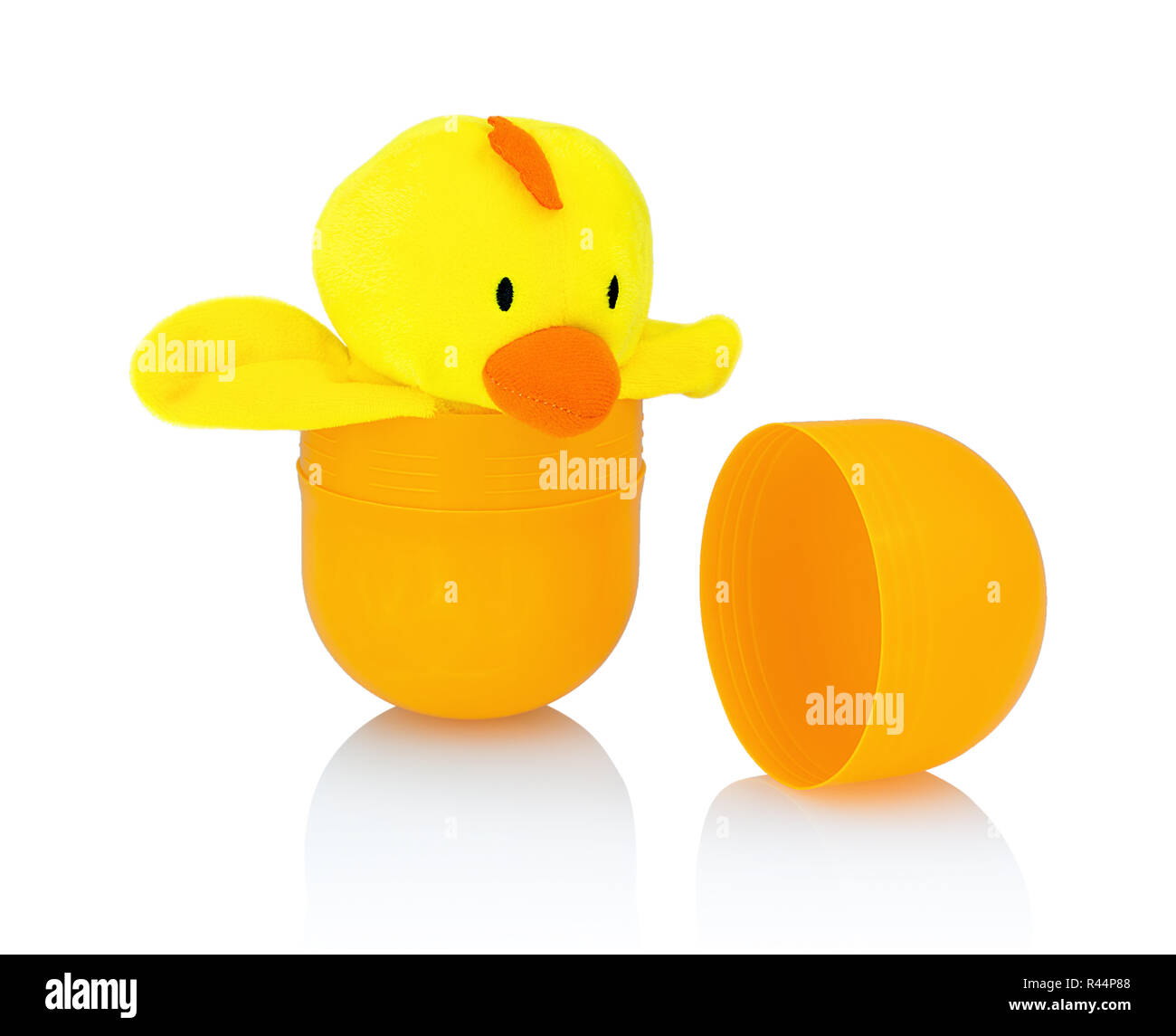 Chicken plush doll isolated on white background with shadow reflection. Yellow chick getting / breaking out of its shell isolated on white underlay. N Stock Photo
