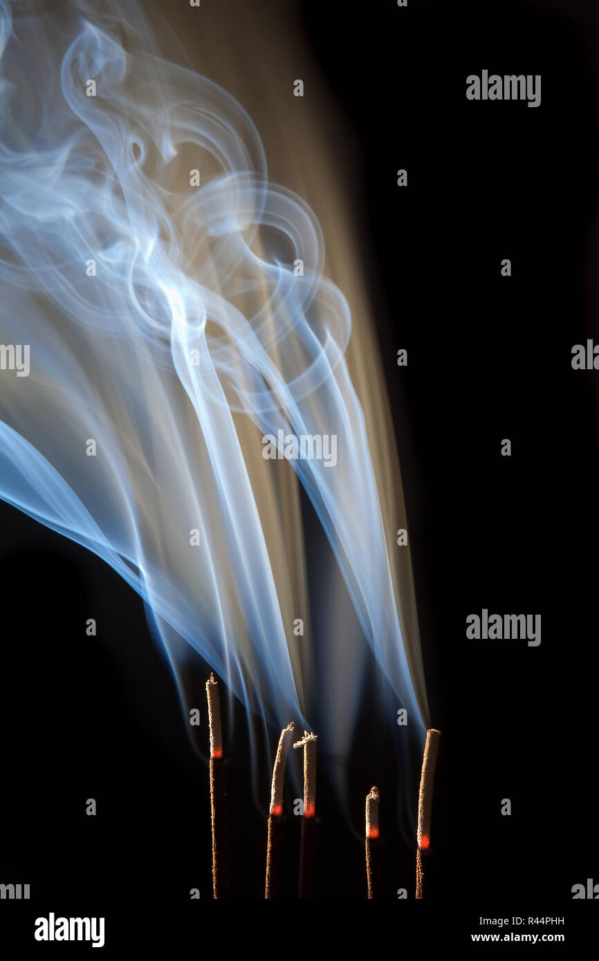 Incense burning with beautiful smoke fumes and wisps Stock Photo ...