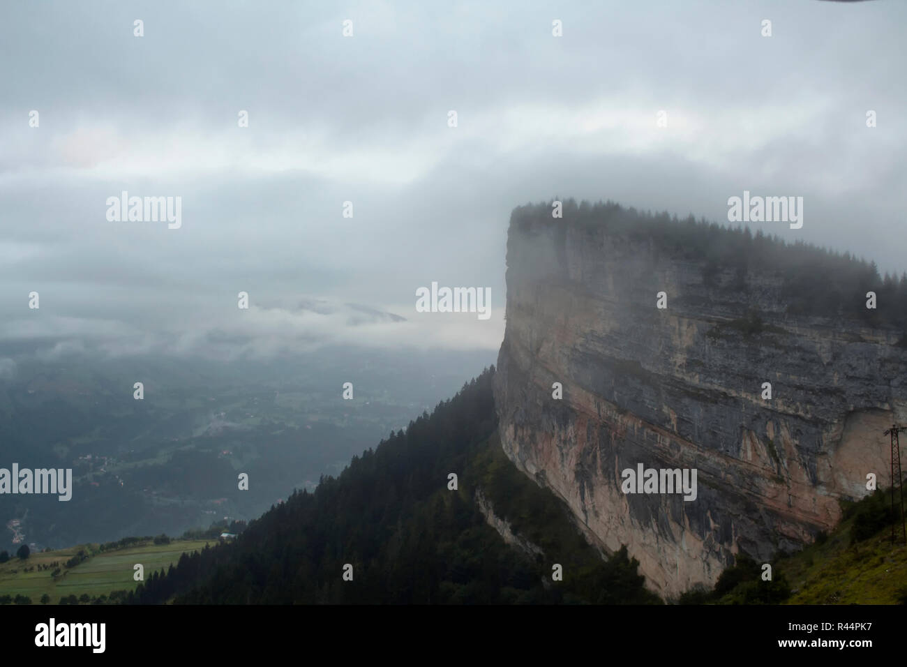 View of a big rock on top of a mountain, valley, trees and beautiful nature in fog. The image is captured in Trabzon/Rize area of Black Sea region loc Stock Photo