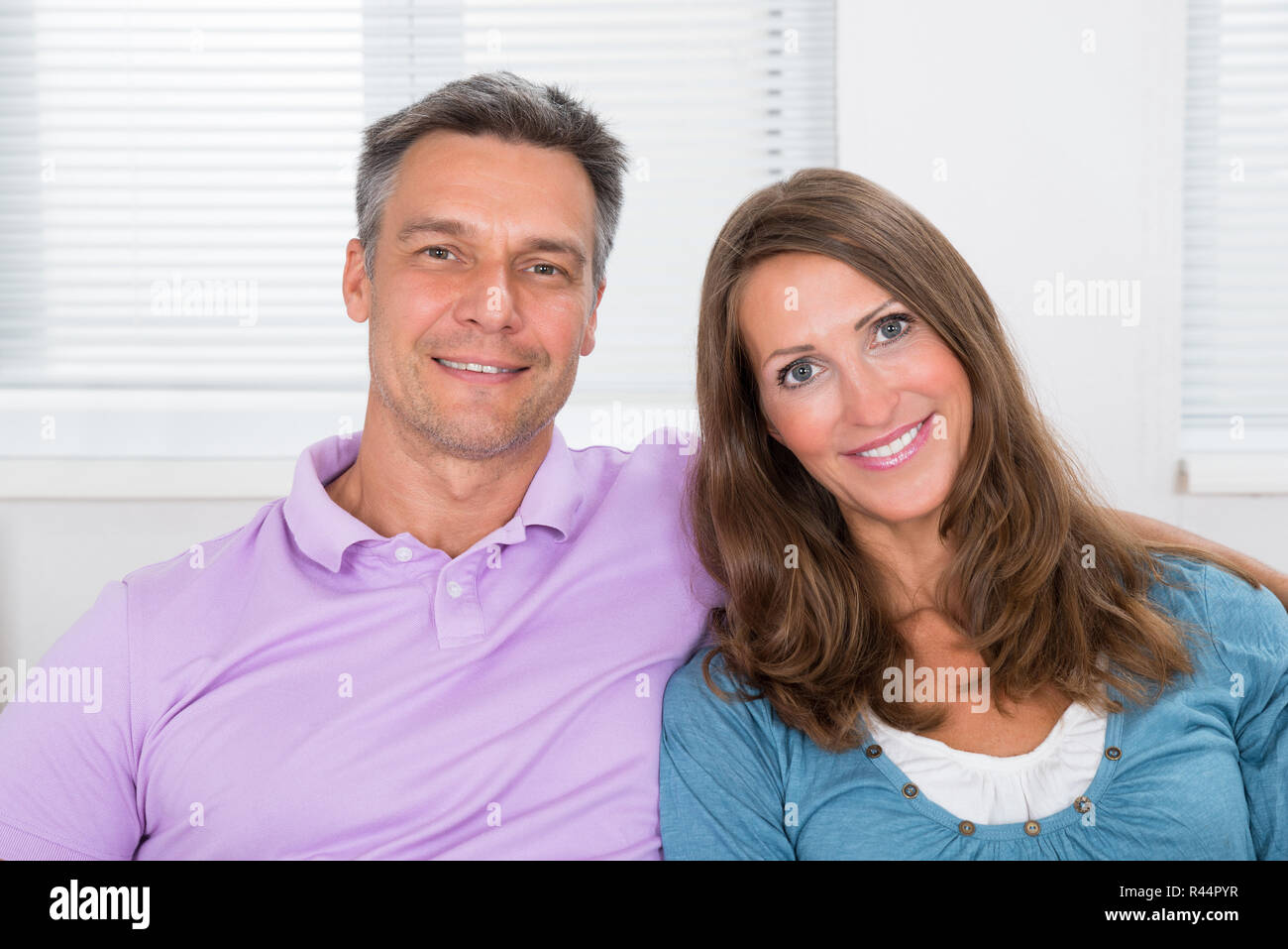 Couple Sitting On Couch Stock Photo Alamy