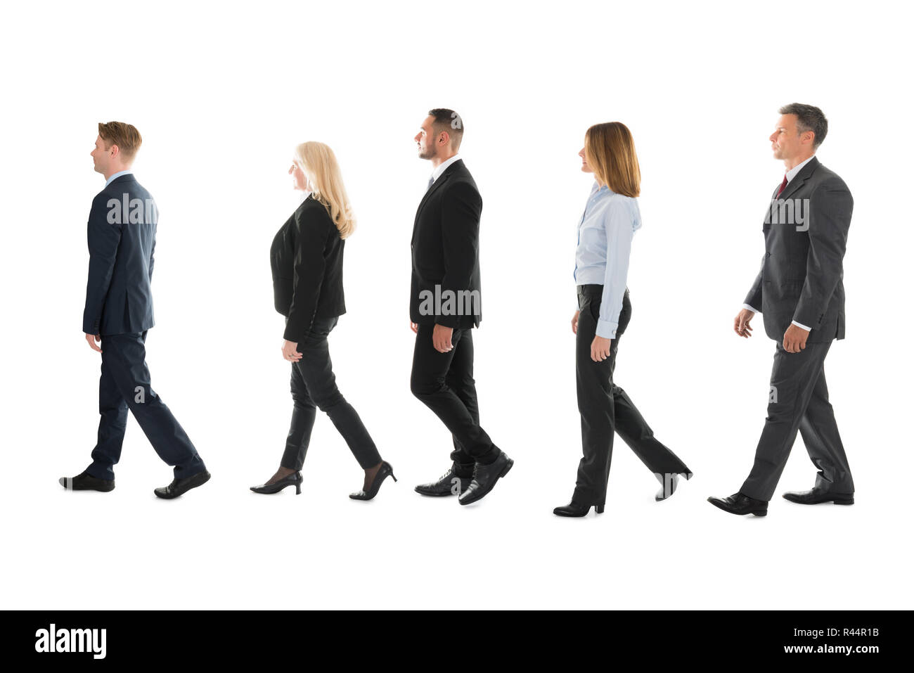 Business People Walking Against White Background Stock Photo