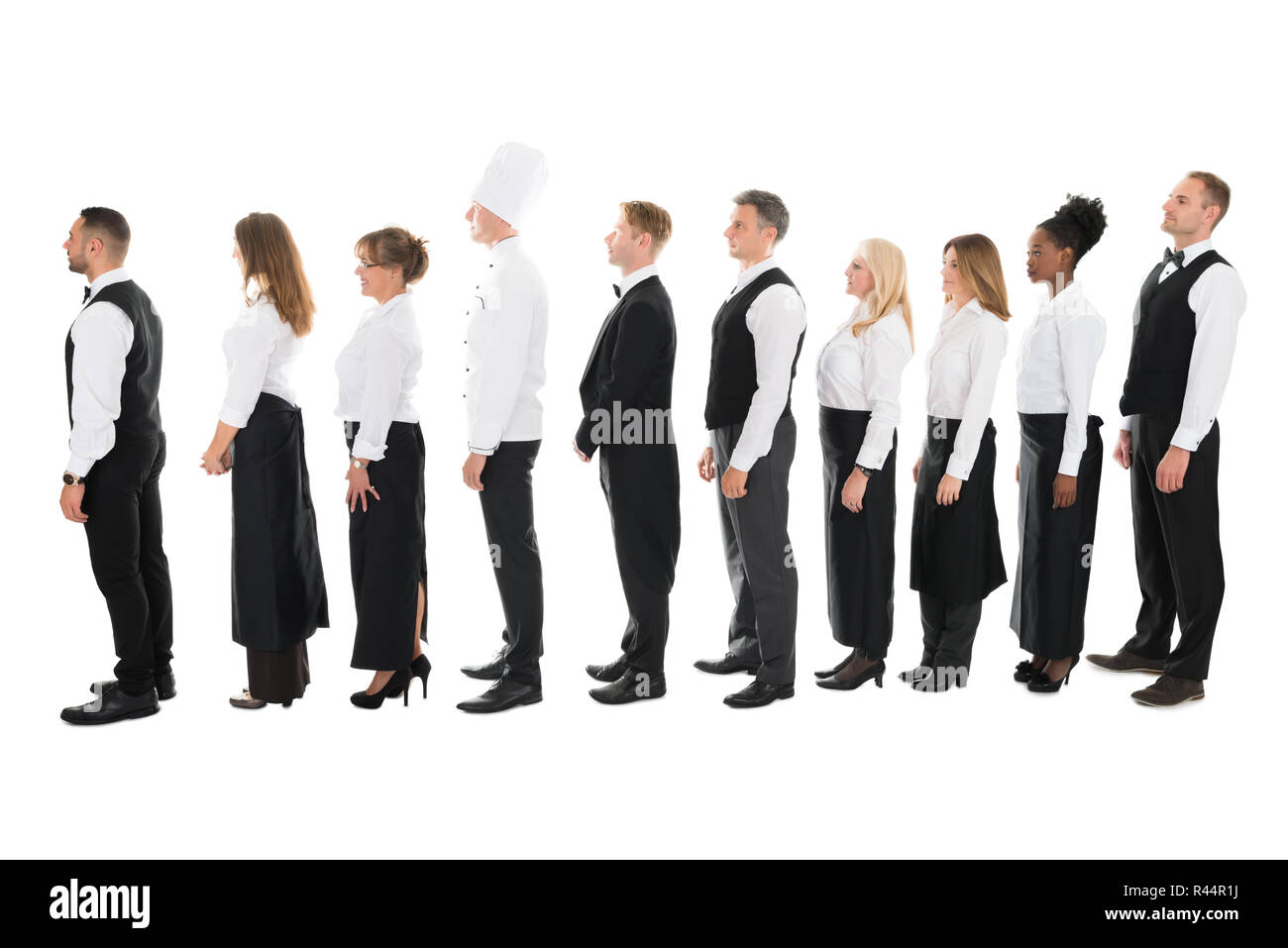 Side View Of Restaurant Staff Standing In Line Stock Photo