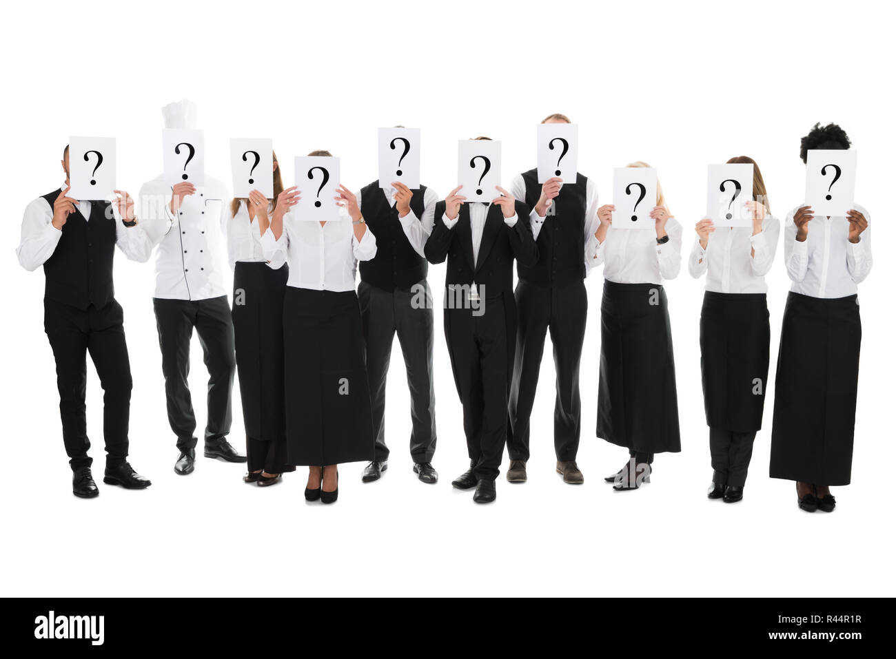 Restaurant Staff Hiding Faces With Question Mark Signs Stock Photo