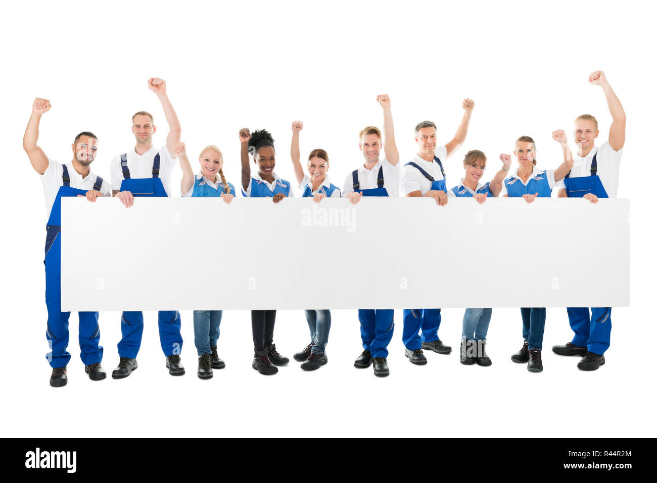 Happy Janitors With Arms Raised Holding Blank Billboard Stock Photo