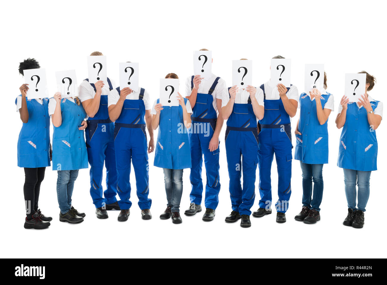 Janitors Hiding Faces With Question Mark Signs Stock Photo