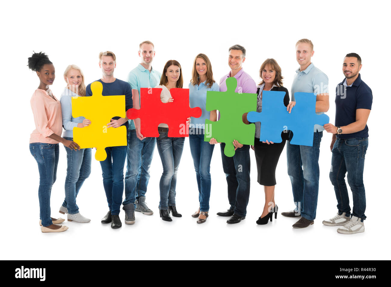 Creative Business People Holding Jigsaw Pieces Stock Photo