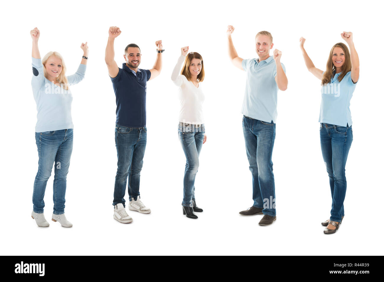 Confident People In Casuals Standing With Arms Raised Stock Photo