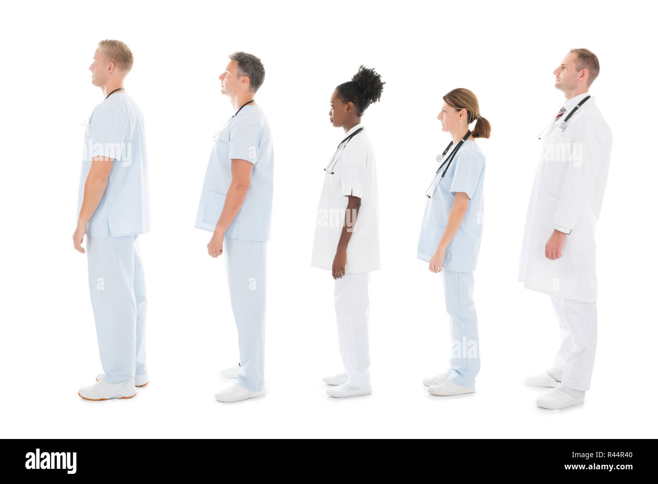 Side View Of Medical Team Standing In Row Stock Photo