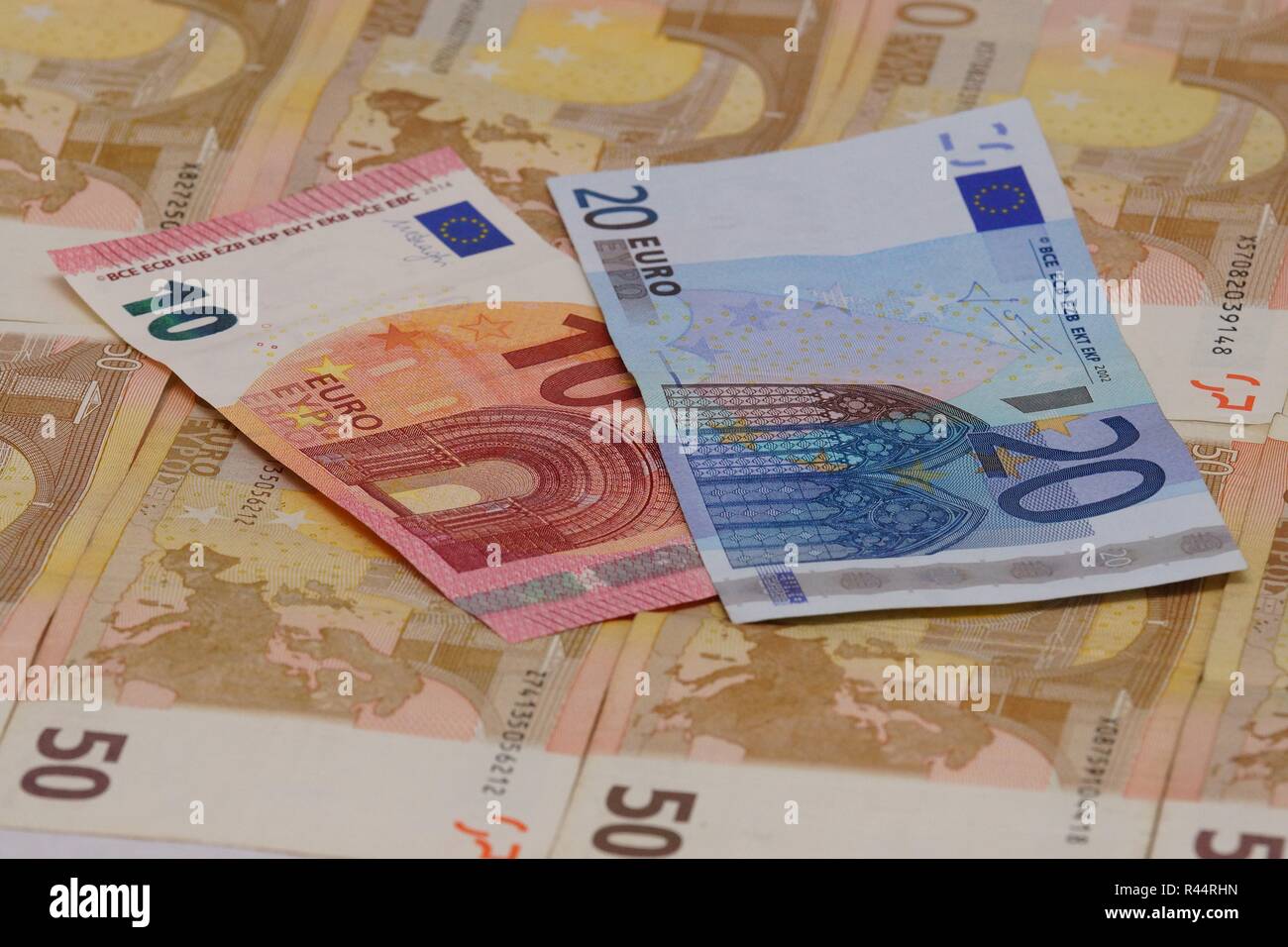 a ten and a twenty euro note fifty euro bills lying on several Stock Photo